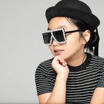 Child wearing Square Diamond Frame Sunglasses in black with a black hat and striped shirt
