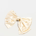 Ivory satin bow hair clip for girls with pearl accents and Maudysh logo charm