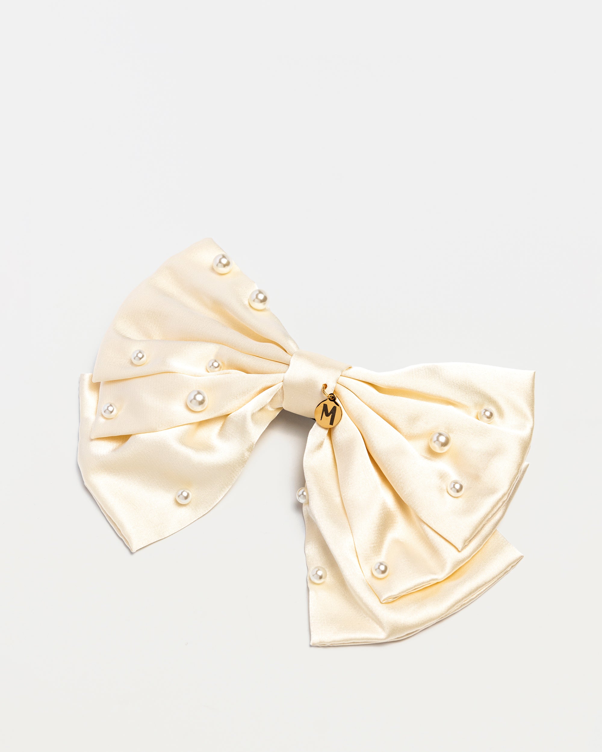 Ivory satin bow hair clip for girls with pearl accents and Maudysh logo charm