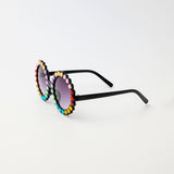 Carrousel Color sunglasses in side angle showing black arms and rainbow rhinestones on round frames