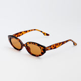 Vero Sunglasses in cheetah print with amber lenses and playful oval frames