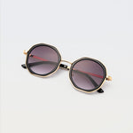 Goddess Cream sunglasses with black octagon frames, gold rims, and dark tinted lenses
