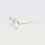Side view of Goddess Cream sunglasses showing white temple tips and gold arms with engraved detailing