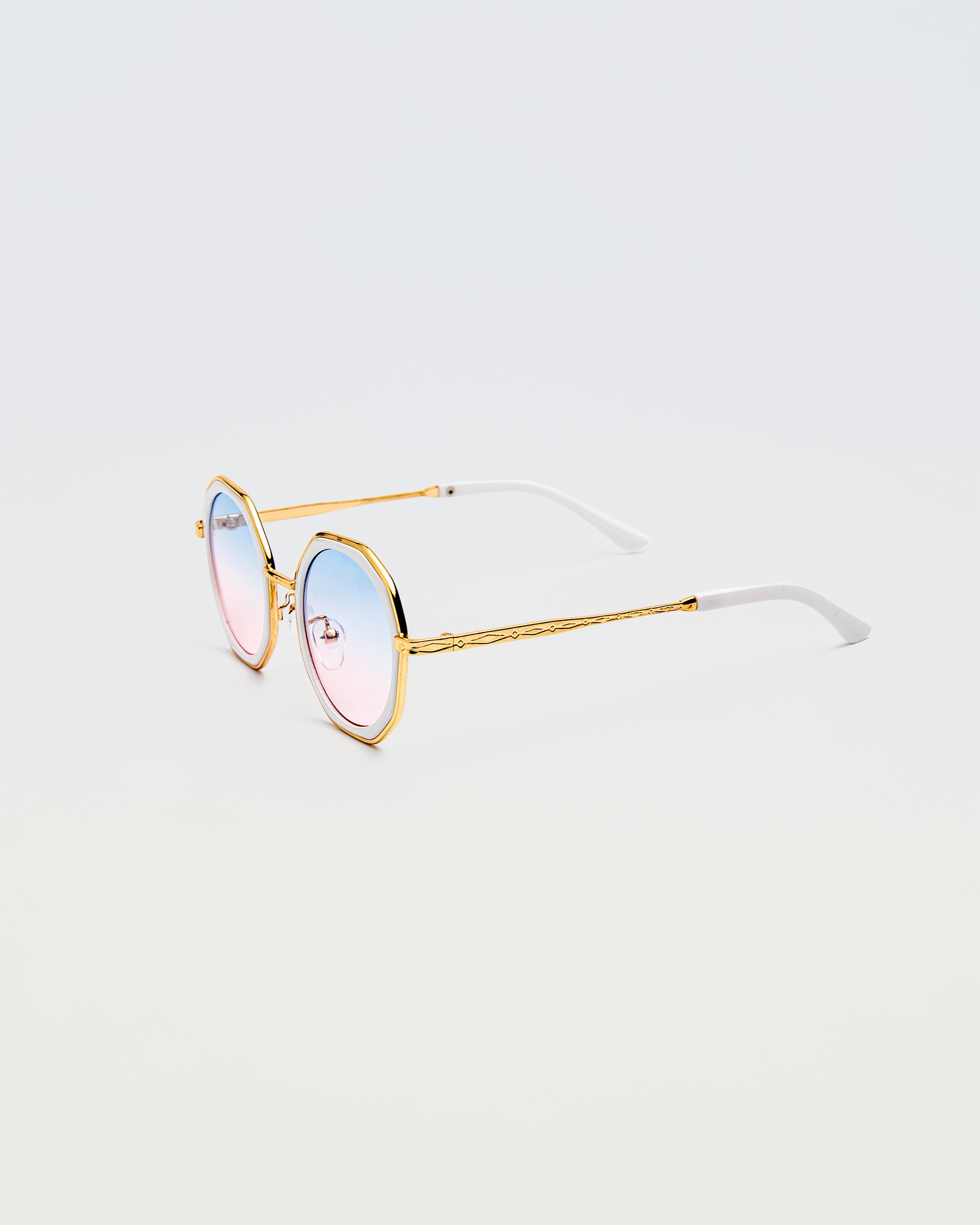 Side view of Goddess Cream sunglasses showing white temple tips and gold arms with engraved detailing