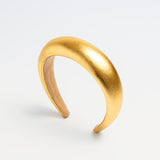 Shiny gold padded headband for kids with a smooth rounded silhouette