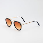 Jet Set sunglasses with black and gold aviator-style frames and warm brown tinted lenses on white background