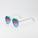 Jet Set sunglasses with turquoise and gold aviator-style frames and cool purple tinted lenses on white background