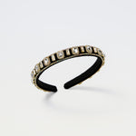 Black kids headband with clear rectangular gems and gold trim