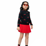 The orange lensed, black heart shaped sunglasses worn by a model in a red and black cherry themed outfit