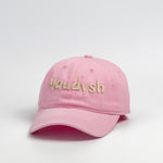 A bubblegum pink baseball cap with the word Maudysh embroidered on the front