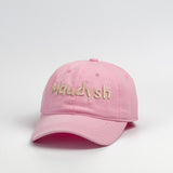A bubblegum pink baseball cap with the word Maudysh embroidered on the front