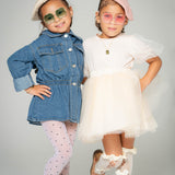 Two girls wearing Apple Delight sunglasses in pink and green with pearl berets and fashion outfits