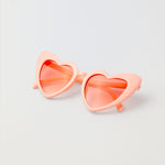 Pink heart-shaped kids sunglasses with playful princess design
