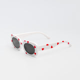 White sunglasses for kids with red heart print and black lenses