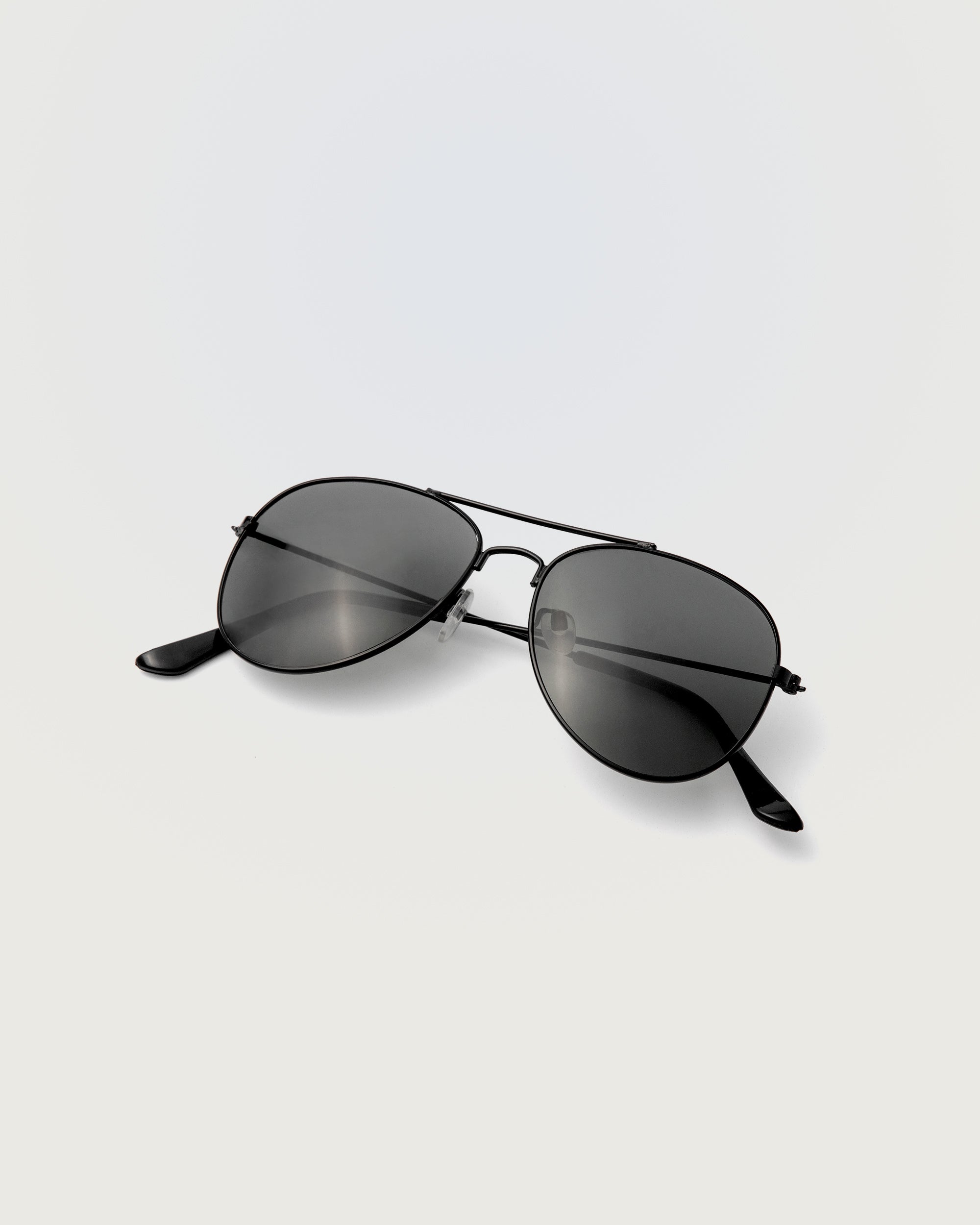 Rockstar Sunglasses in black aviator frame with dark tinted lenses displayed on white background