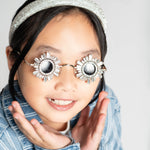 Girl smiling while wearing Starstruck Symmetry Sunglasses and striped shirt