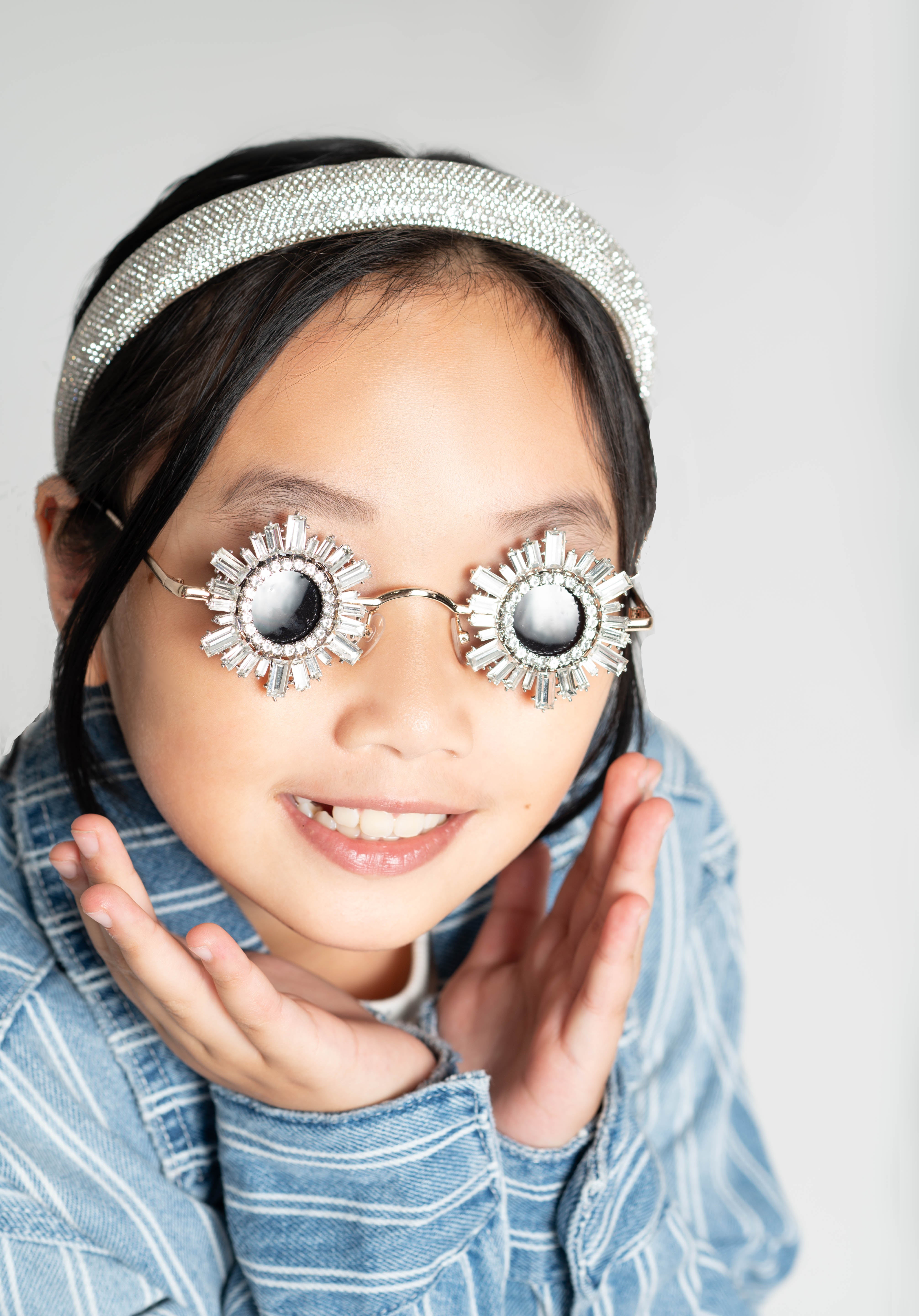 Girl smiling while wearing Starstruck Symmetry Sunglasses and striped shirt
