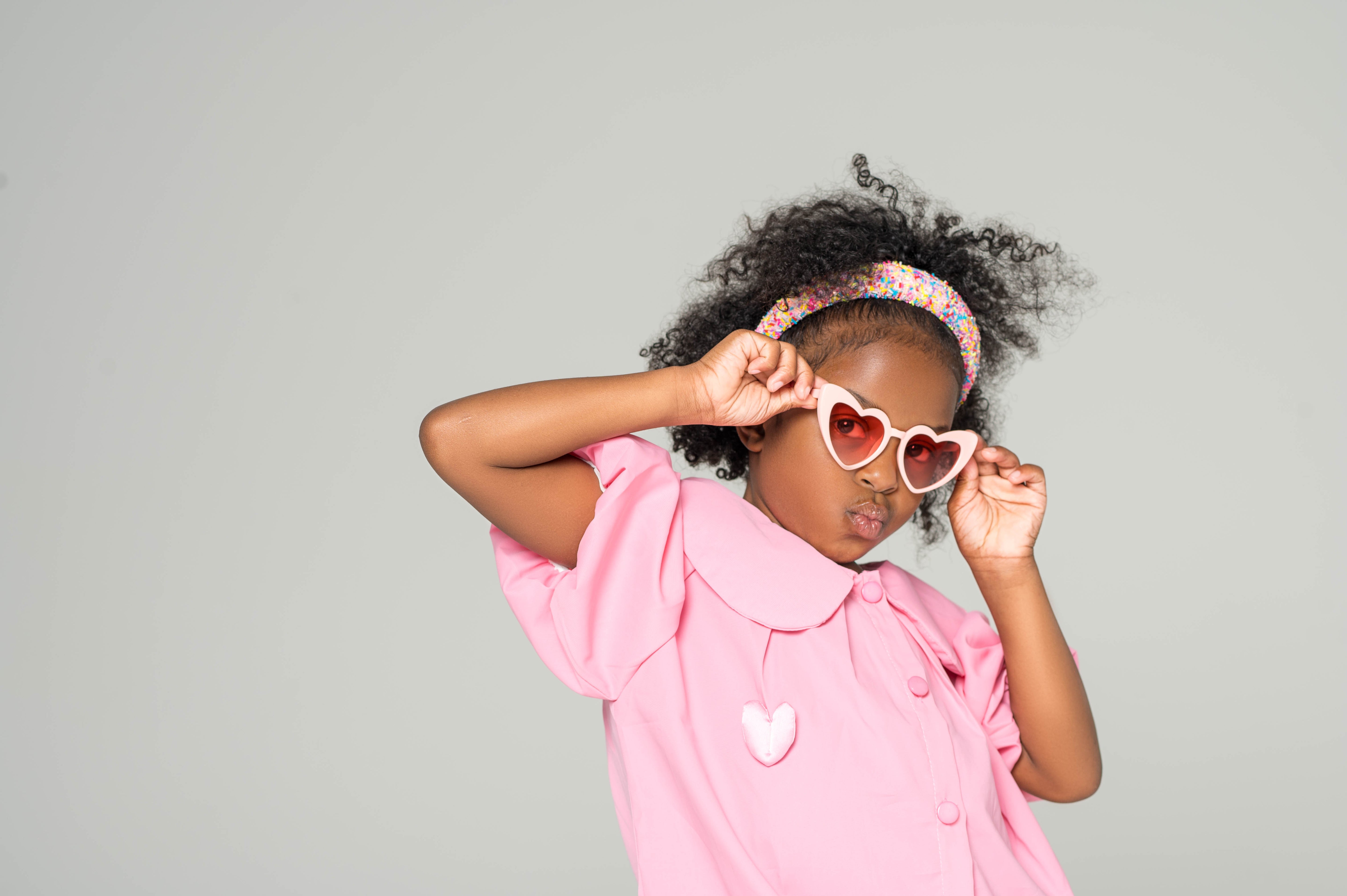 Close-up of child wearing pink sweetheart princess sunglasses