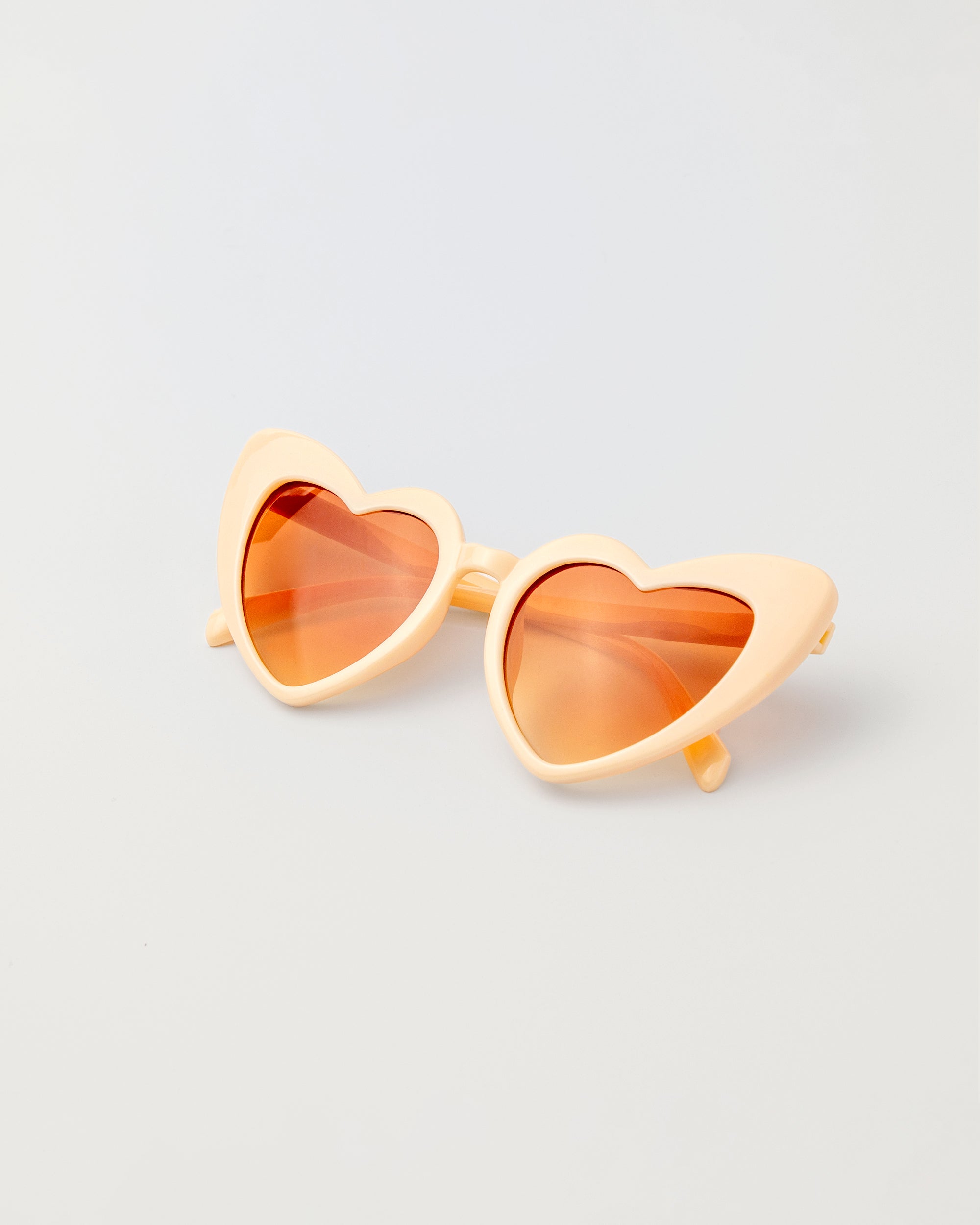 Cream-colored heart sunglasses for kids with soft princess appeal